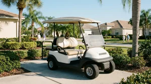 golf cart parked on residential community path near palm trees and homes